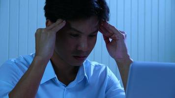 Young man had vision fatigue and a headache due to overwork at night. photo
