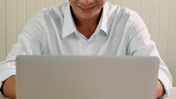 Asian Businessman working with laptop on the desk. photo