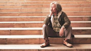 Unhappy man sitting on stairs. photo