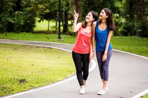 Attractive young women walking after exercise in a park photo
