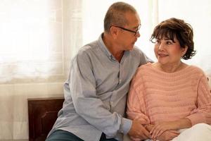 Happy asian couples sitting together in the house. photo