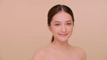 Beautiful face of Asian young woman with natural skin. Portrait of attractive girl with soft makeup and perfectly beautiful skin. photo