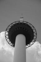 Top of Kyoto Tower from below in black and white photo