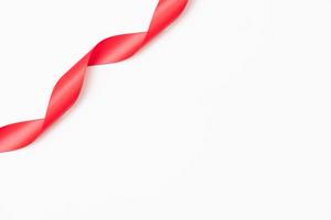 Curly red ribbons on white background photo