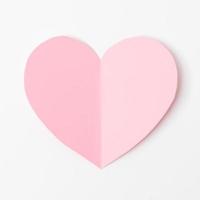Shape of heart flying on white paper background. photo