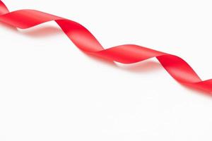 Curly red ribbons on white background photo