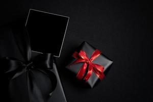 Top view of free space for text with black gift box isolated on black background. photo