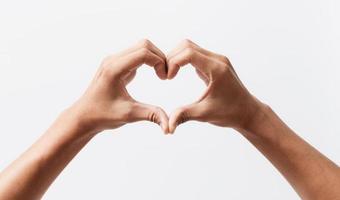 Man hands making a heart shape on a white isolated background Premium Photo