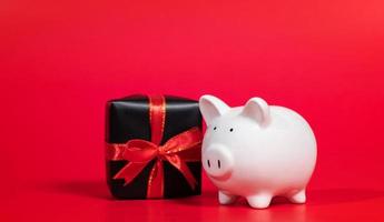 Composition with piggy bank isolated on red background. photo