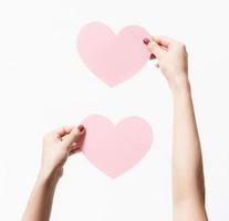 Close up women holding pink blank paper on white background Premium Photo