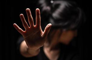 Woman with her hand extended signaling to stop photo