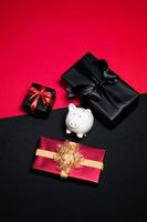 Top view of black gift box with red and black ribbons isolated on black background. photo