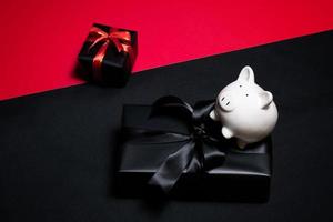 Top view of black gift box with red and black ribbons isolated on black background. photo