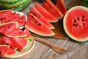 Watermelon slice and cut half on wooden background, Closeup sweet watermelon slices pieces fresh watermelon tropical summer fruit photo