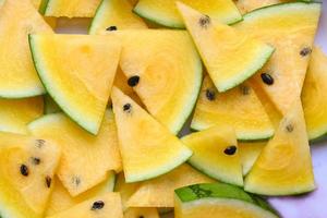 Yellow watermelon slice on background, Closeup pile of sweet watermelon slices pieces fresh watermelon tropical summer fruit photo