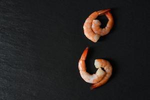 Shrimp on dark background Seafood shellfish four shrimps prawns boiled photo