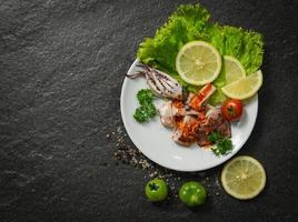 Squid salad plate served with chilli sauce spicy herbs and spices photo