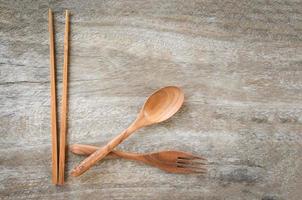 Wooden spoon fork and chopsticks kitchenware set on rustic wooden table photo