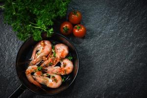 Seafood plate with shrimps prawns cooked on pan photo