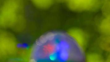Blurred sphere. Blurry background with green color. Unfocused texture of opposite colors. Purple and green. Natural texture movement. video