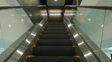 Close up shot of empty moving staircase running up and down. video