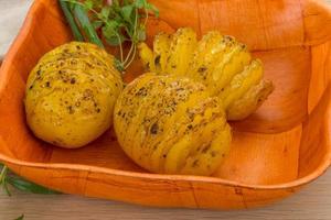 Baked potato in a bowl close up view photo