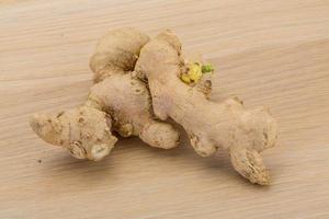 Ginger on wooden background photo