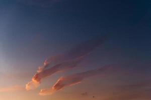 Outdoor horizontal shot of beautiful sky with pastel coloures and bright cumulus. Pink clouds in sky. Texture background. Clean cloudy sunset photo