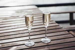 Two glasses of champagne on table photo