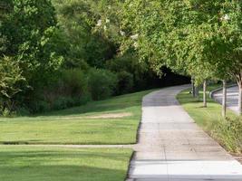 A walking path in the Woodlands, Texas on a sunny day in summer. photo