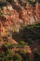 una vista de un barranco en el parque estatal caprock canyons mientras se pone el sol. foto