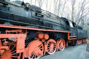 Steam locomotive parked at a terminal station. Historical railroad from 1940 photo