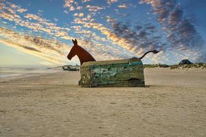 On the beach in Blavand, Denmark looking at a bunker with horse head photo