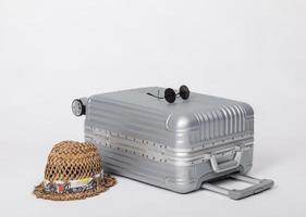 Travel Baggage with hat and sunglasses isolated on white background with copy space, Travel concept background photo