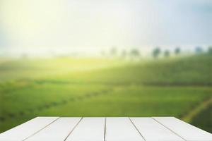 Empty wooden table with view of mountain or wooden desk with plantation nature with bokeh background, copy space for your text photo