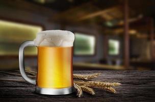 Glass of Light Beer with wheat on the wooden table in the restaurant, with copy space for your text photo