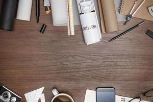 Creative flat lay of architects wooden table with roll blueprints, architectural project plan, engineering tools, office supplies, Workspace for designer concept photo