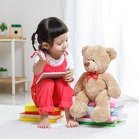 Lovely laughing little child, preschool age toddler girl wearing safety helmet playing indoors building house with colorful photo