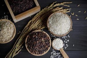 Japan rice with Thai jasmine rice and paddy rice seed on wooden table photo