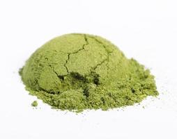 Heap of matcha green tea powder isolated on white background, Organic product from the nature for healthy with traditional style photo