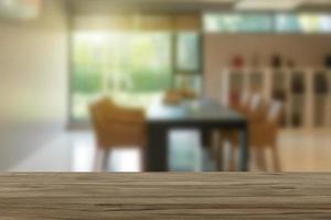 Empty wooden table top with view of office or wooden desk with library room with blur background, copy space for your text photo