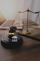 Justice and law concept.Male judge in a courtroom with the gavel, working with, computer and docking keyboard, eyeglasses, on table in morning light photo