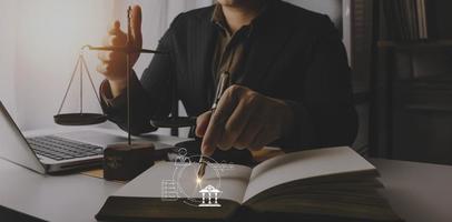 Business and lawyers discussing contract papers with brass scale on desk in office. Law, legal services, advice, justice and law concept picture with film grain effect photo