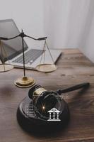 Business and lawyers discussing contract papers with brass scale on desk in office. Law, legal services, advice, justice and law concept picture with film grain effect photo