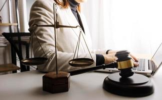 justice and law concept.Male judge in a courtroom on wooden table and Counselor or Male lawyer working in office. Legal law, advice and justice concept. photo