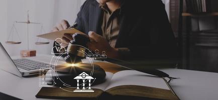 Business and lawyers discussing contract papers with brass scale on desk in office. Law, legal services, advice, justice and law concept picture with film grain effect photo