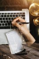 Male lawyer working with contract papers and wooden gavel on tabel in courtroom. justice and law ,attorney, court judge, concept. photo