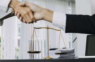 Justice and law concept. Gavel on sounding block in hand's Male judge at a courtroom, working with document law books, report the case on table in modern office. photo