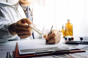 Medicine doctor and stethoscope touching icon medical network connection with modern interface on digital tablet in hospital background. Medical technology network concept photo