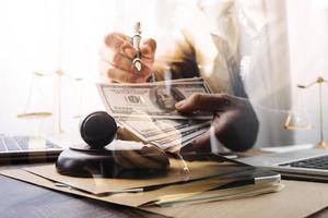 Business and lawyers discussing contract papers with brass scale on desk in office. Law, legal services, advice, justice and law concept picture with film grain effect photo